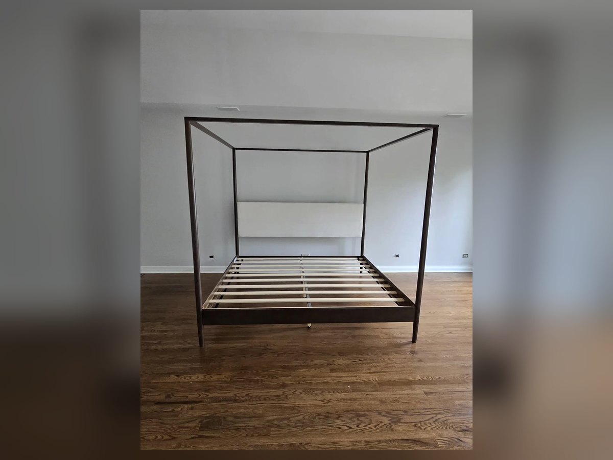 Four-poster canopy bed frame assembled