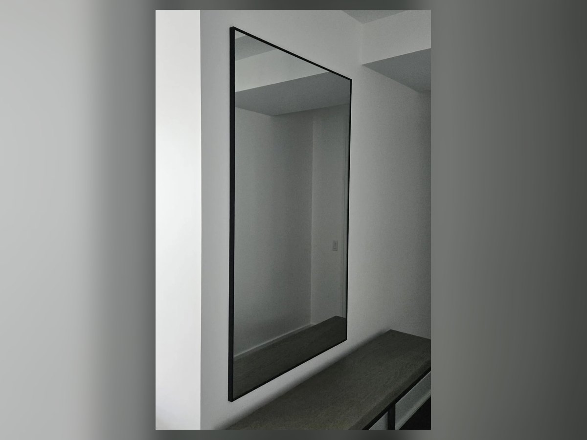 Large full-length mirror hung on wall