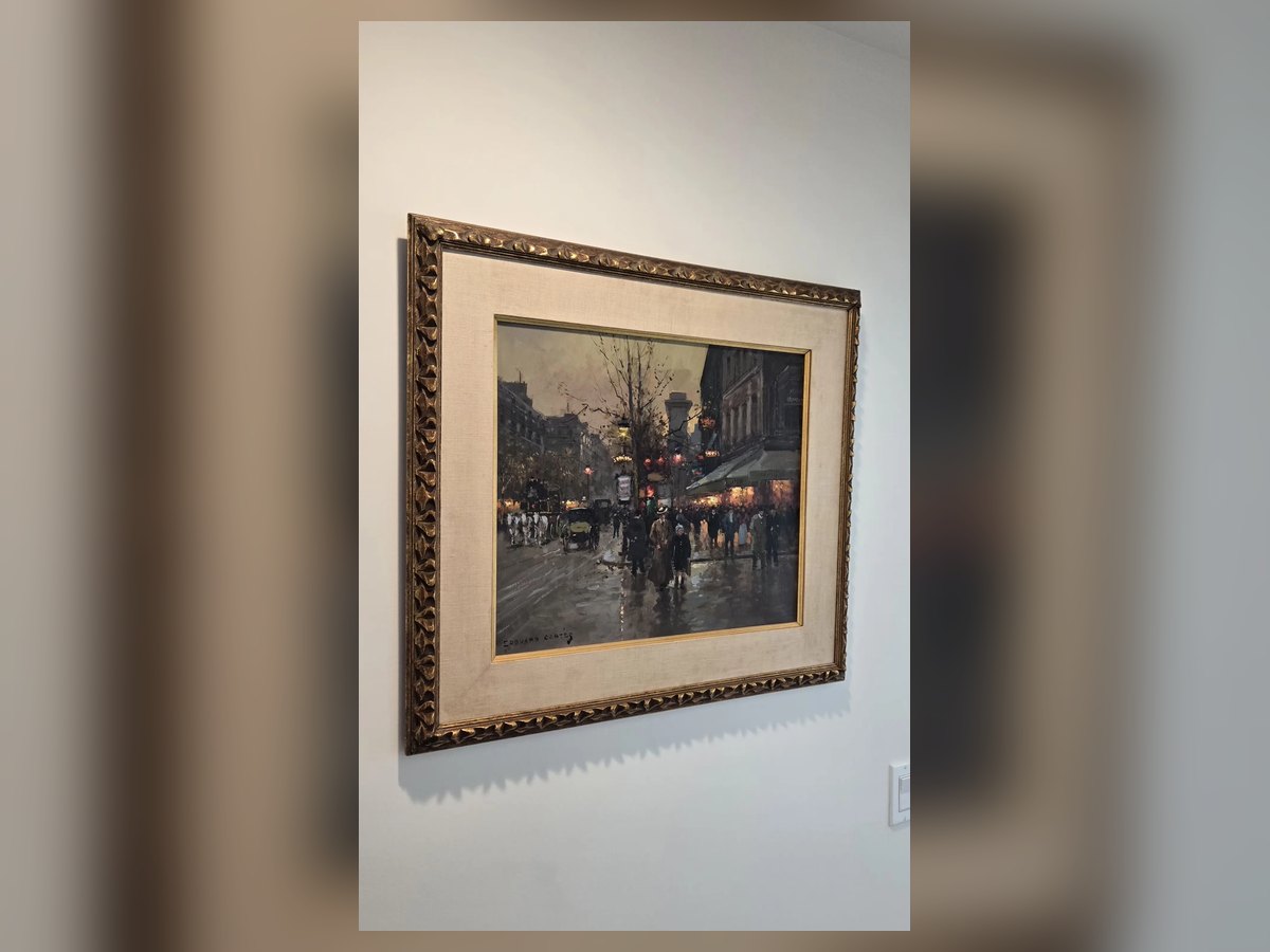 Large gold-framed painting hung on a wall