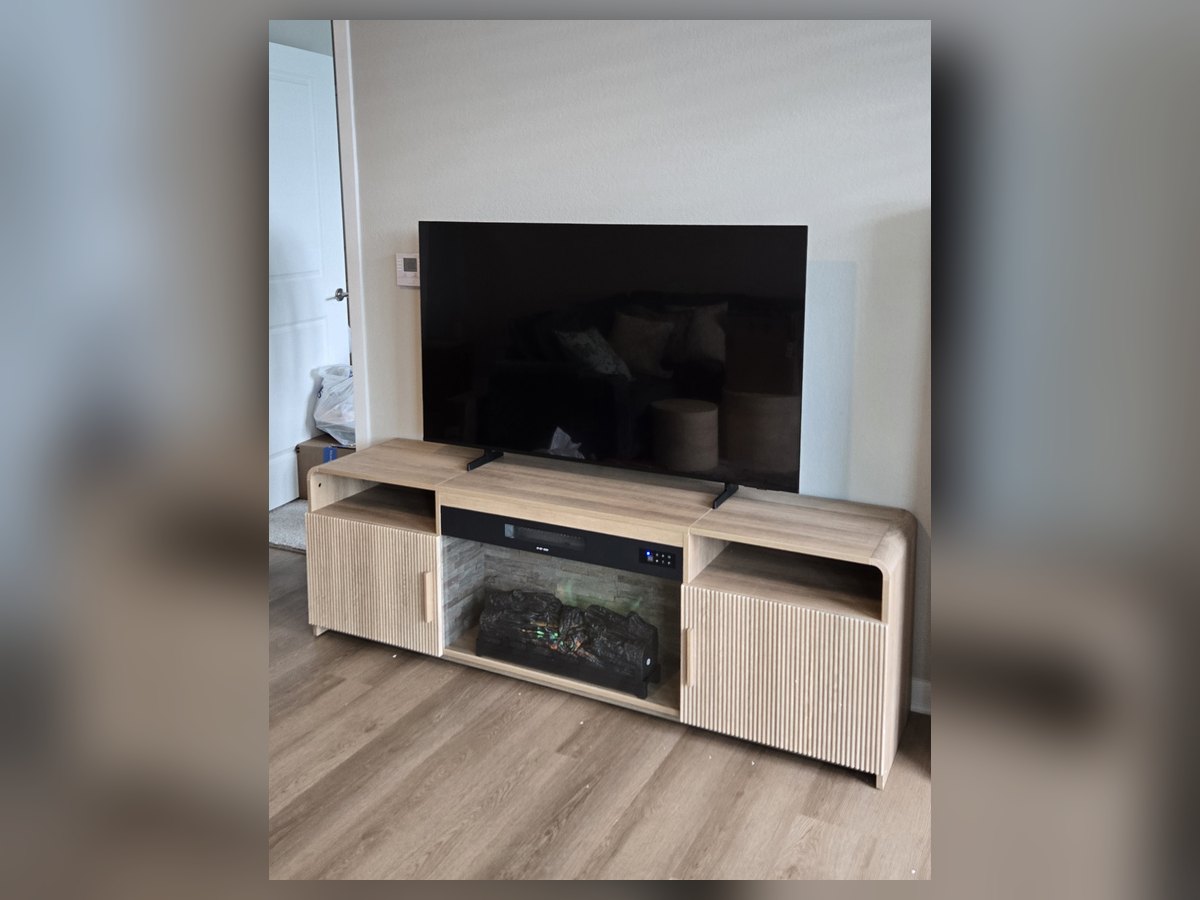 TV set up on a media console with electric fireplace